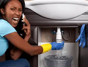 Emergency plumbing repair for a leaking sink drain under a bathroom vanity in Indianapolis, IN
